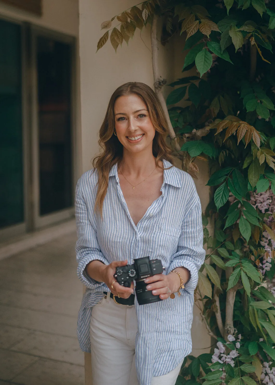 Shelby, photographer and storyteller, holding her camera in Venice